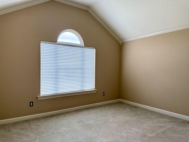 spare room with light carpet, crown molding, and vaulted ceiling