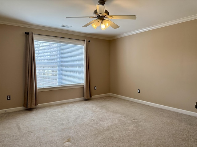 spare room featuring ornamental molding, light carpet, and ceiling fan