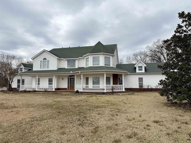 view of front of home with a porch and a front yard