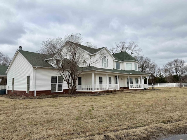 view of front of property with cooling unit, a porch, and a front yard