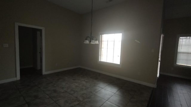 empty room featuring an inviting chandelier