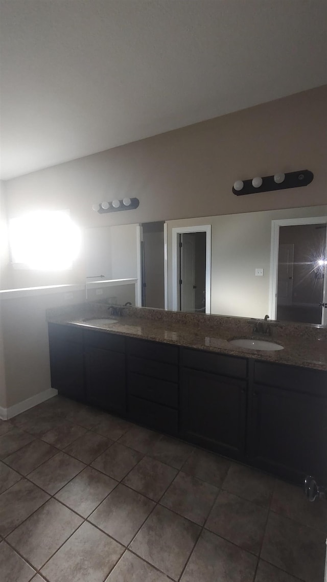 full bathroom with tile patterned flooring, a sink, and double vanity