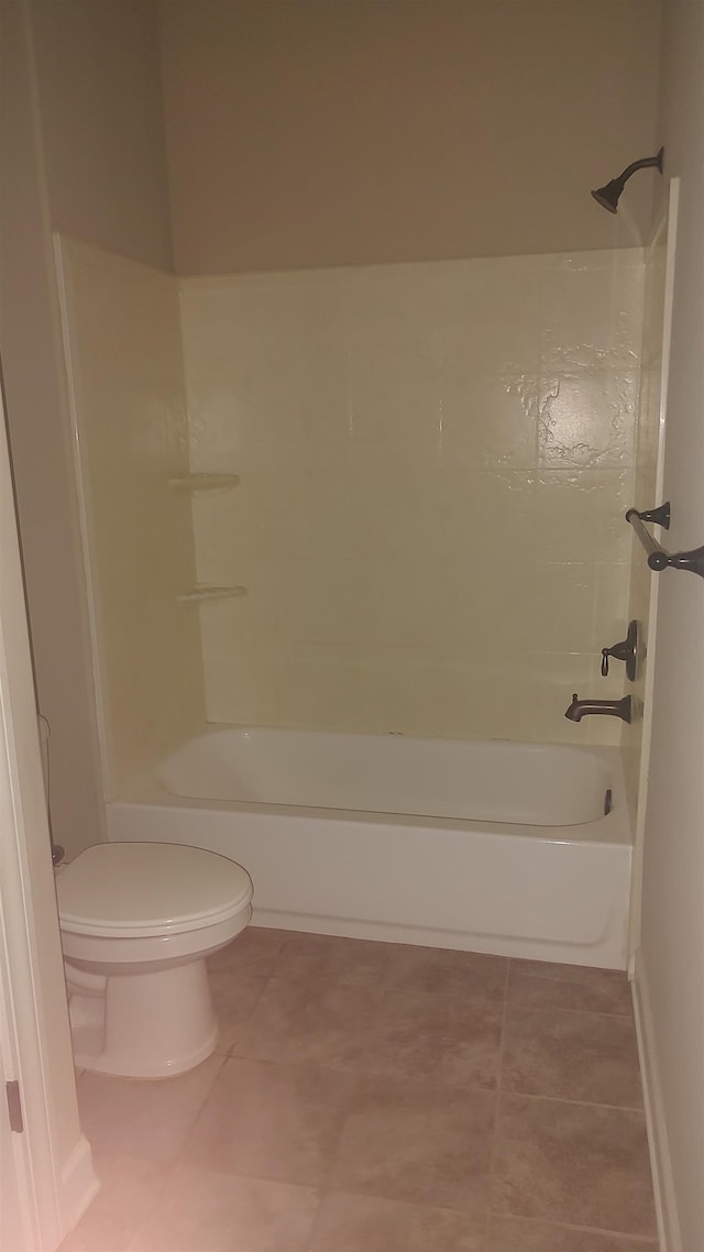 bathroom with toilet, bathing tub / shower combination, and tile patterned floors