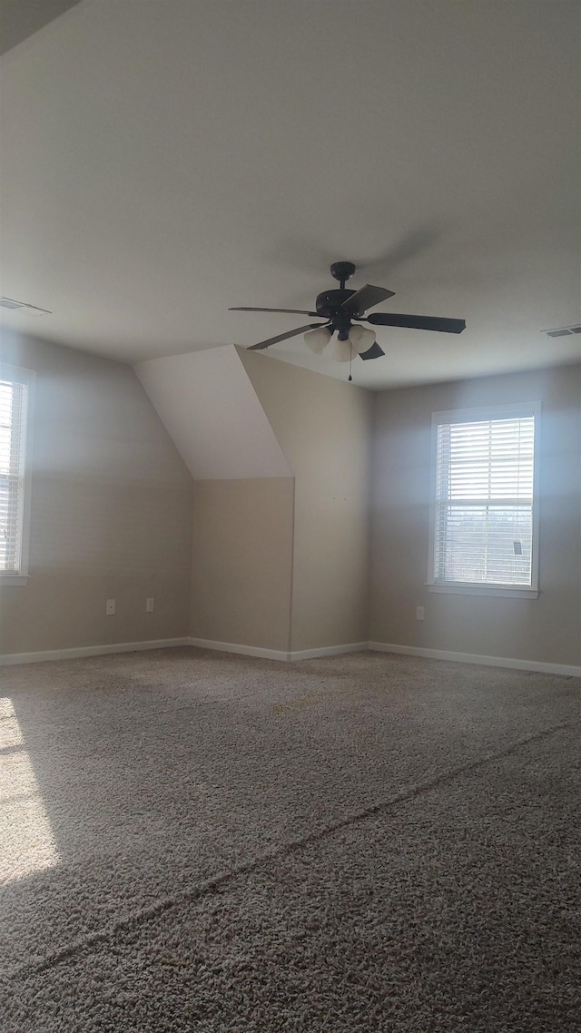 additional living space with visible vents, ceiling fan, and baseboards