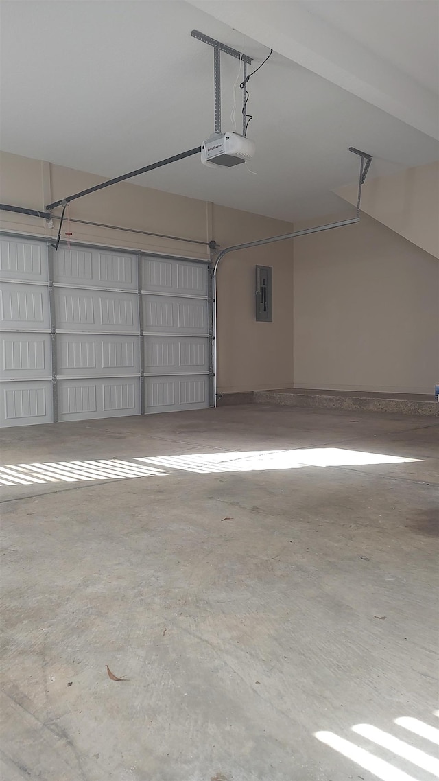 garage with a garage door opener and electric panel