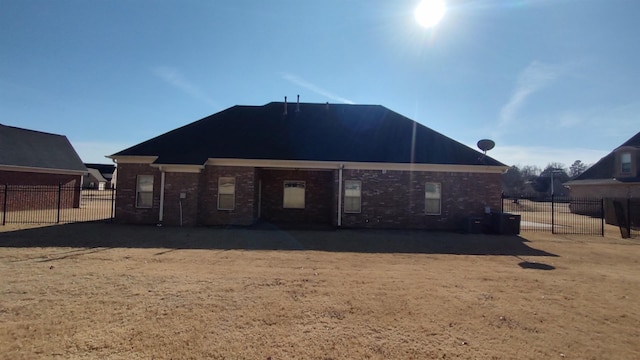 rear view of property featuring fence