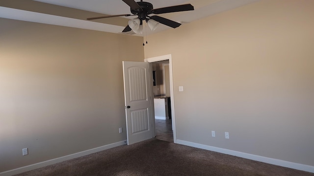 unfurnished room featuring ceiling fan and dark carpet