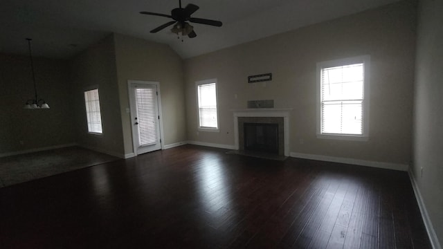 unfurnished living room with dark hardwood / wood-style floors, ceiling fan, plenty of natural light, and a fireplace