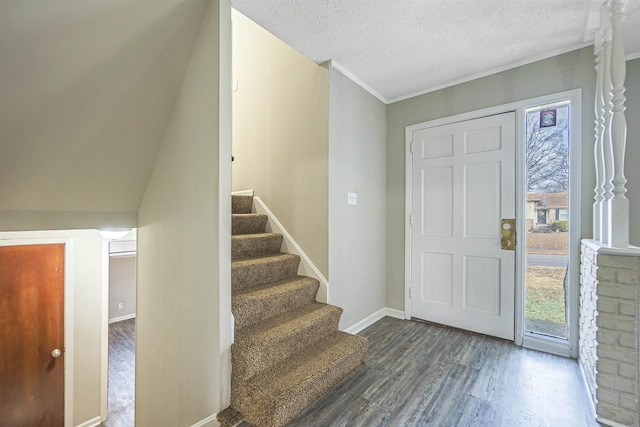 entrance foyer featuring dark hardwood / wood-style floors and a textured ceiling