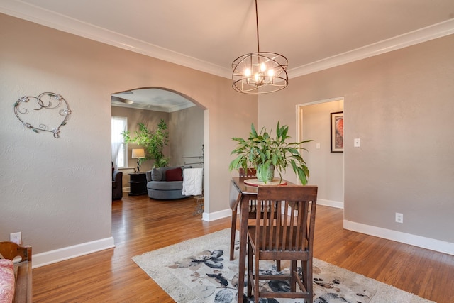 dining area featuring hardwood / wood-style floors and ornamental molding