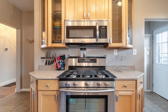 kitchen featuring light brown cabinetry and stainless steel appliances