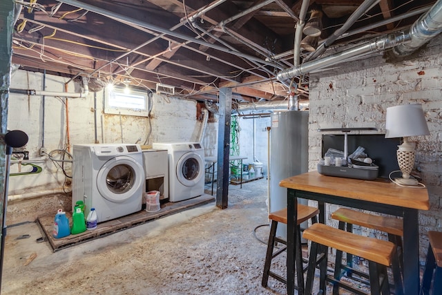 clothes washing area with washing machine and clothes dryer and water heater