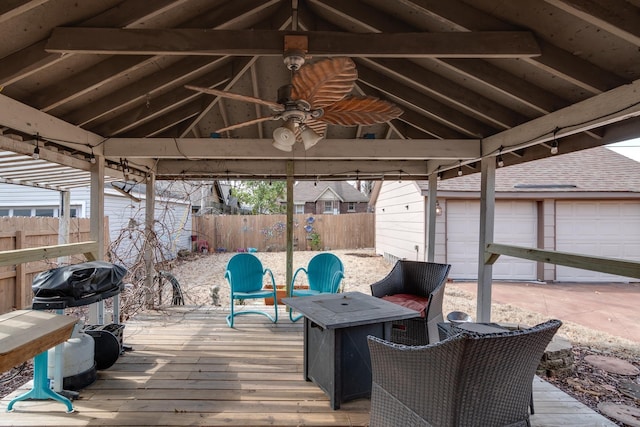 wooden deck featuring a gazebo, area for grilling, ceiling fan, and an outdoor fire pit