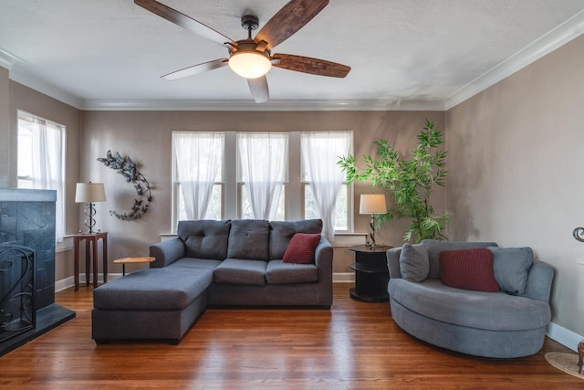 living room featuring wood-type flooring, ornamental molding, and a wealth of natural light