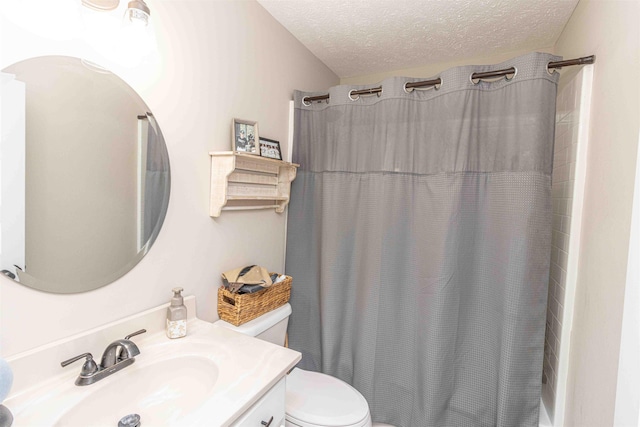 bathroom with a shower with curtain, vanity, toilet, and a textured ceiling