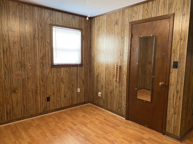 empty room featuring a textured ceiling and light wood-type flooring