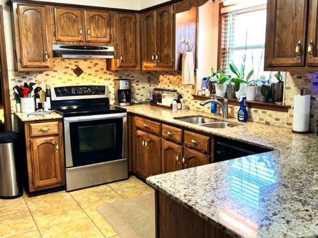 kitchen featuring ventilation hood, sink, light tile patterned floors, light stone counters, and stainless steel electric range