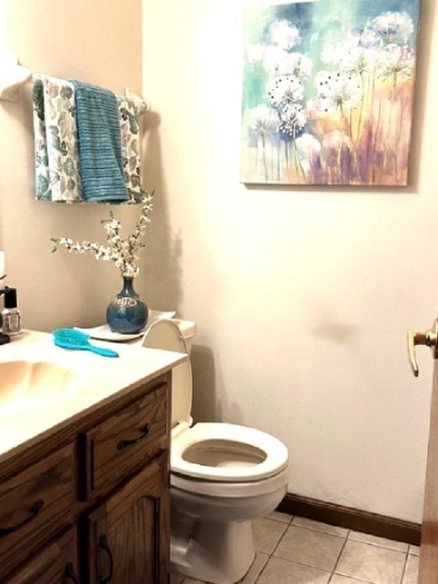 bathroom with vanity, toilet, and tile patterned flooring