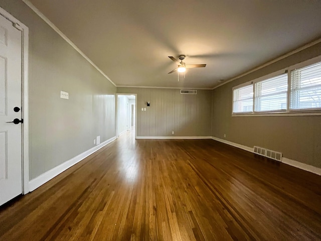 unfurnished room with crown molding, ceiling fan, and dark hardwood / wood-style floors