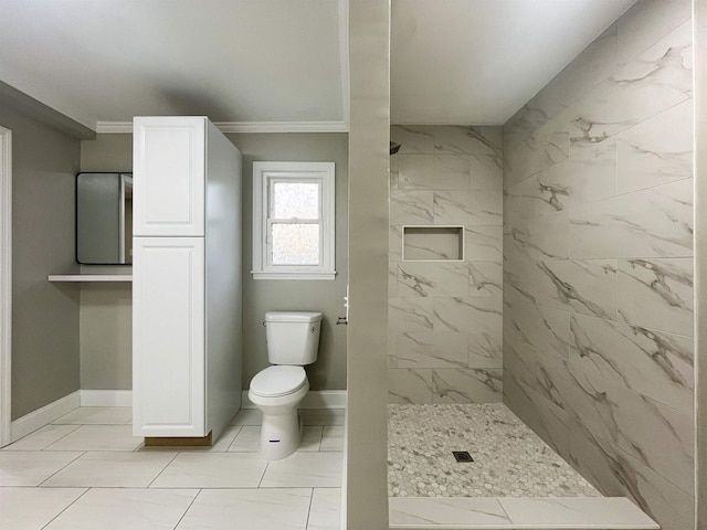 bathroom with crown molding, toilet, and a tile shower