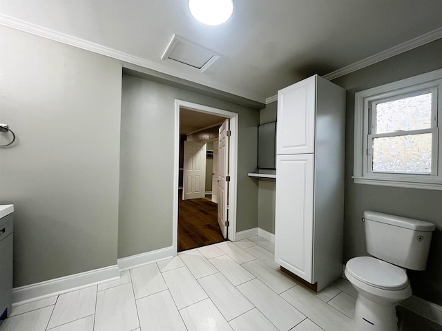 bathroom featuring vanity, ornamental molding, and toilet