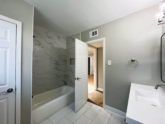 bathroom featuring vanity and tiled shower / bath combo