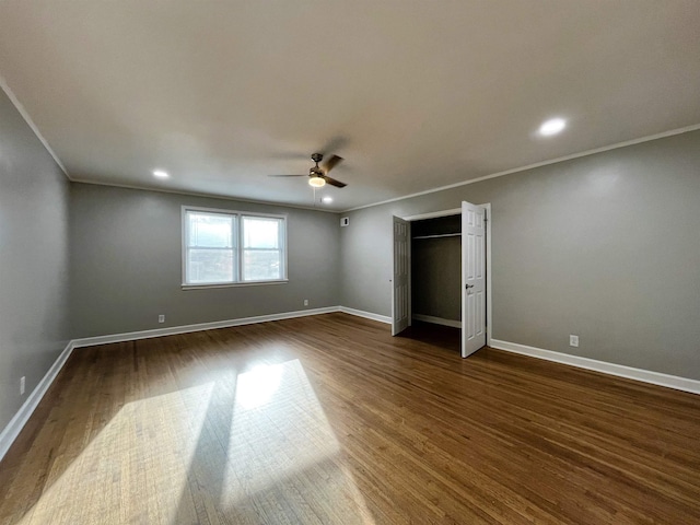 unfurnished bedroom featuring dark hardwood / wood-style flooring, crown molding, and ceiling fan