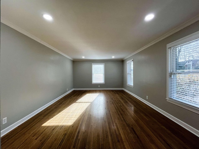 empty room featuring dark wood-type flooring and ornamental molding