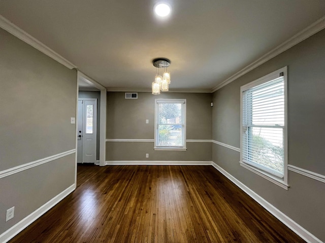 unfurnished dining area with ornamental molding, a notable chandelier, and dark hardwood / wood-style flooring