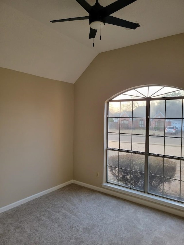 unfurnished room with carpet floors, ceiling fan, and vaulted ceiling