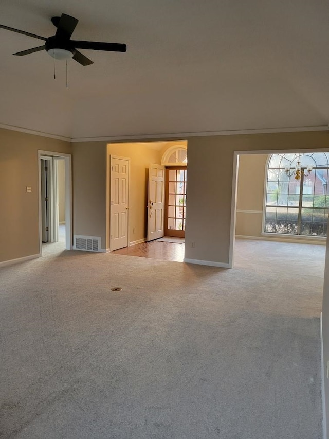 spare room with ceiling fan, ornamental molding, and light carpet