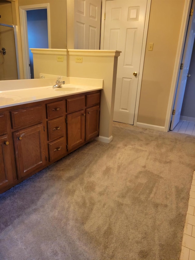 bathroom featuring vanity and a shower with door