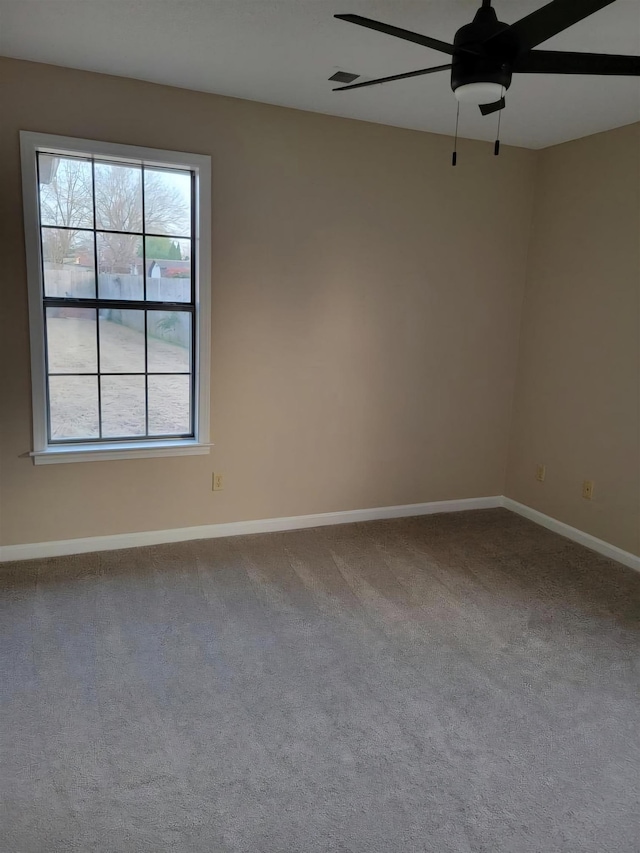 spare room featuring ceiling fan and carpet