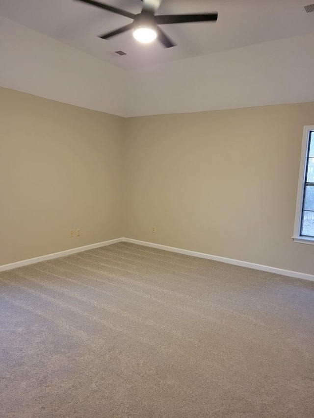 spare room featuring ceiling fan and carpet