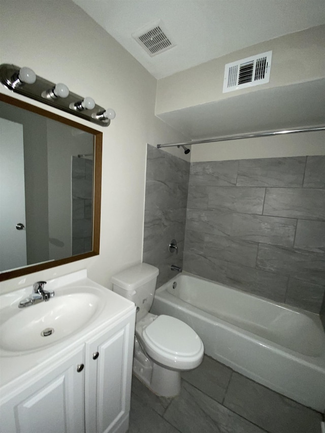 full bathroom with tiled shower / bath combo, vanity, and toilet