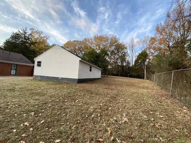 view of side of property with a yard