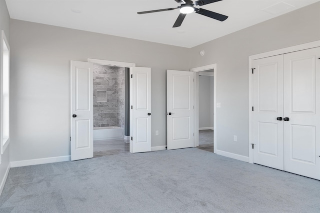 unfurnished bedroom featuring light carpet, connected bathroom, a closet, and ceiling fan