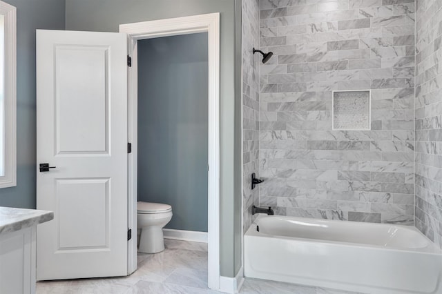 full bathroom featuring vanity, tiled shower / bath combo, and toilet