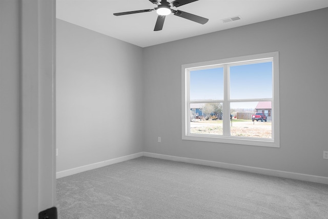 carpeted spare room with ceiling fan