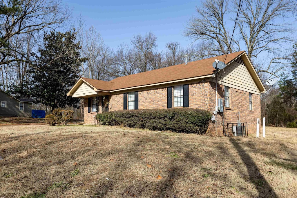 single story home featuring a front lawn