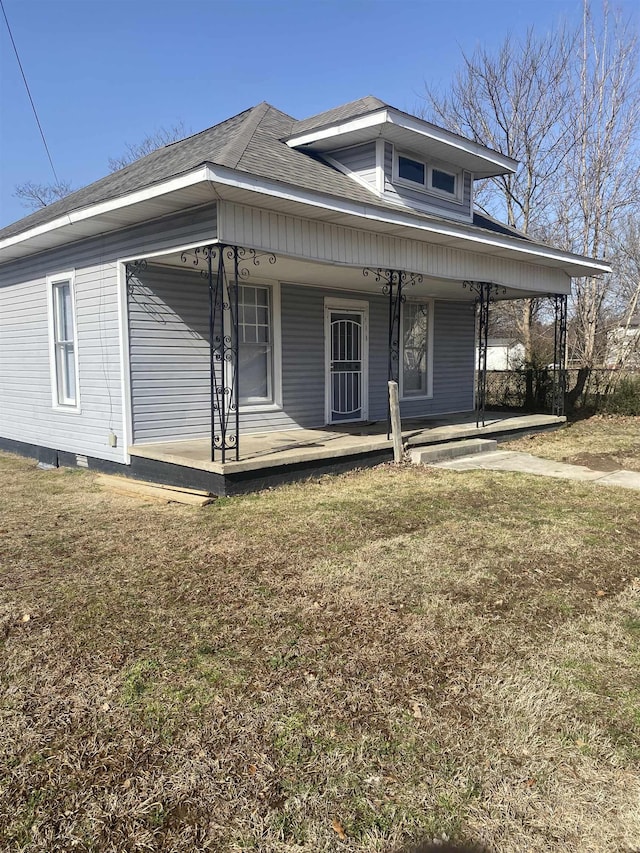 view of front of house with a front yard and covered porch