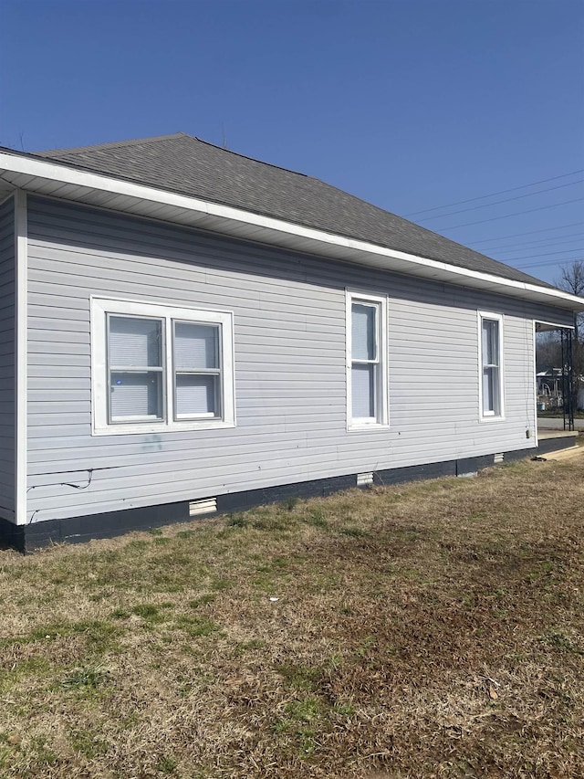 view of property exterior with a lawn