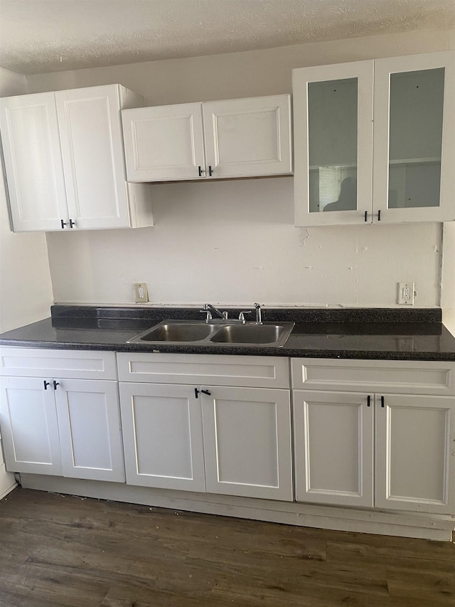 kitchen with sink, white cabinets, and dark hardwood / wood-style flooring