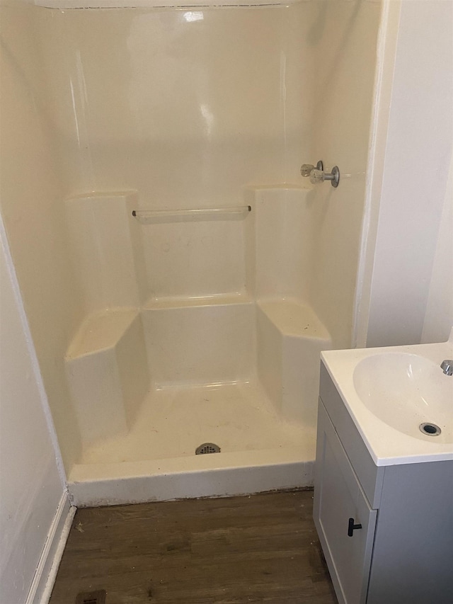 bathroom with vanity, hardwood / wood-style floors, and a shower