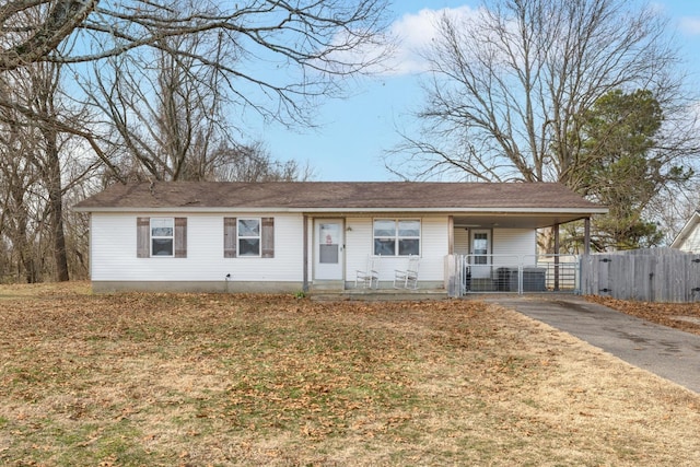 ranch-style home featuring covered porch and a front lawn