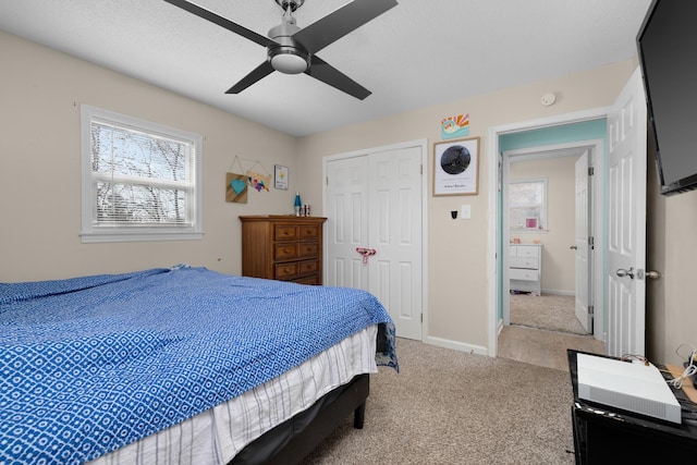 carpeted bedroom with a closet and ceiling fan