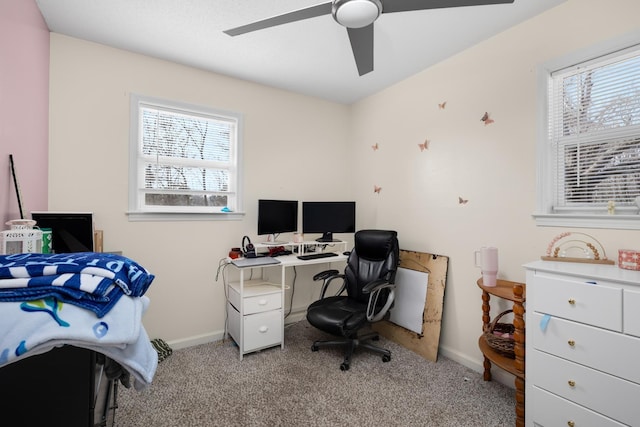 carpeted home office featuring ceiling fan