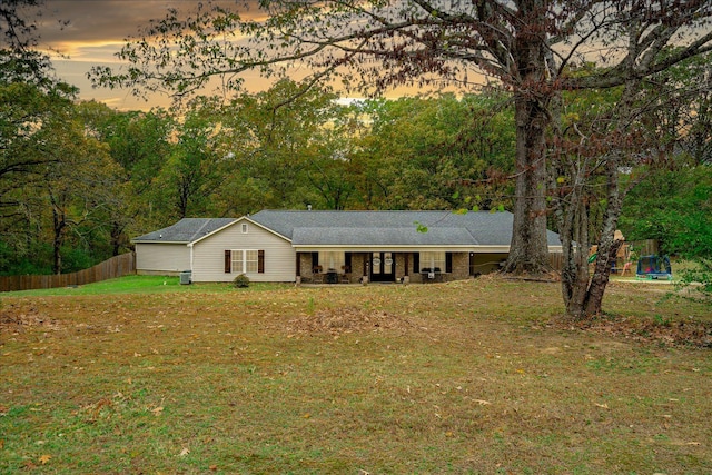 ranch-style home with a yard