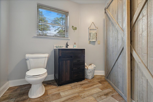 bathroom with hardwood / wood-style floors and toilet