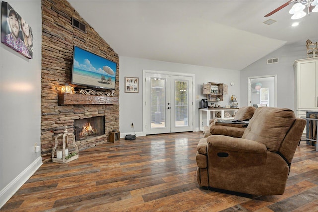 living room with dark wood-type flooring, a fireplace, french doors, and a healthy amount of sunlight